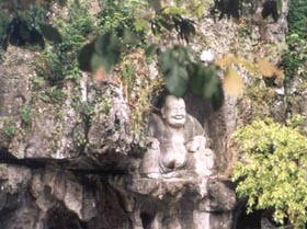 Laughing Buddha Sits in Grotto